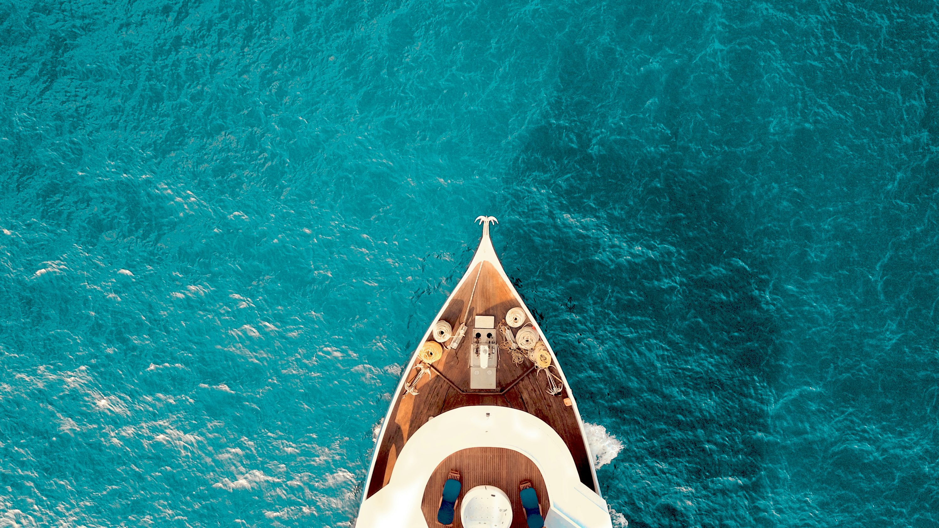 Luxury charter yacht cruising in clear coastal waters